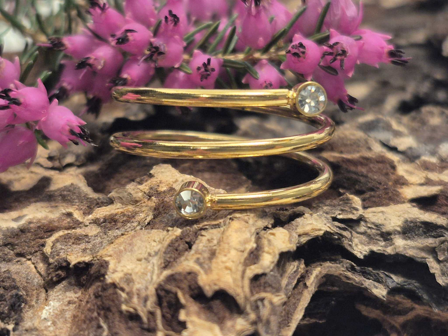 Elegant Sovereign Spiral gold ring featuring sparkling stones